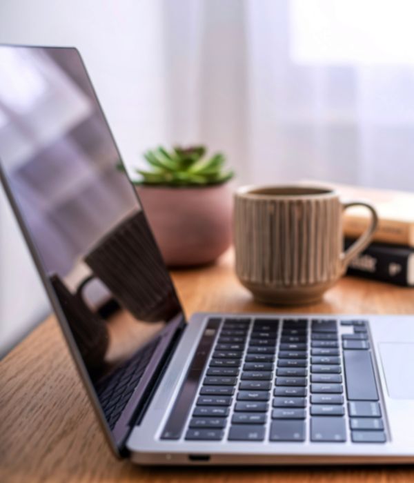 Minimal workspace with laptop, coffee, and succulent plant