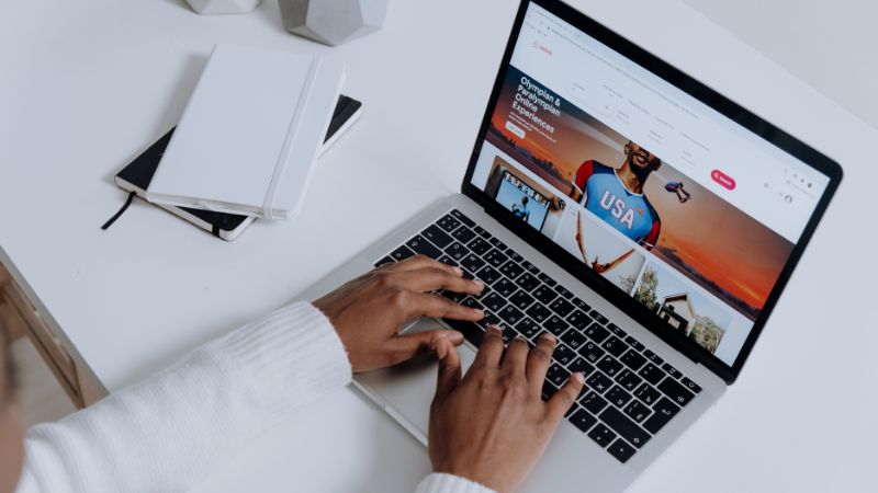 Person browsing website on laptop for performance analysis